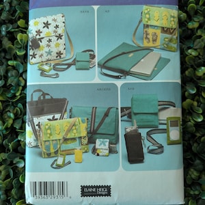May include: Simplicity sewing pattern 4391 featuring various bag designs. The pattern includes images of messenger bags, small pouches, and a laptop case. The cover has the text "ONE SIZE" and "ELAINE HEIGL Designs".