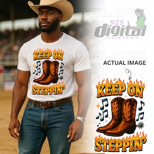 May include: White t-shirt with a graphic of brown cowboy boots, musical notes, and the text "KEEP ON STEPPIN'" in orange and black. The design is surrounded by flames. The shirt is worn by a person.