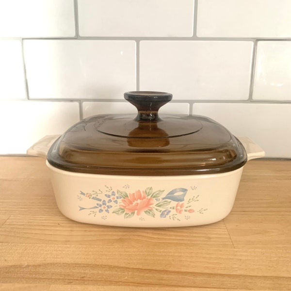 Symphony  Corning Ware Casserole Dish Blue Pink Green Floral Motif With Blue Ribbon On  Cream Background Brown Glass Lid 1990-94   1 Liters