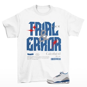 May include: A white short-sleeve t-shirt featuring blue text that reads TRIAL & ERROR with red star accents. Below, smaller text reads Calculat3d, Risk, and a paragraph about chasing dreams. A white, blue, and grey sneaker is positioned at the bottom.