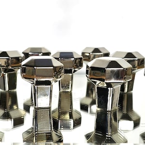 May include: Eight silver-toned, faceted, diamond-shaped cabinet knobs with a polished finish.