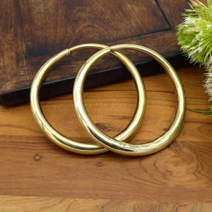 May include: A set of three ceramic mugs with a speckled, matte finish. The mugs are in shades of cream, light gray, and dark gray. Each mug has a simple, minimalist design, perfect for coffee or tea.