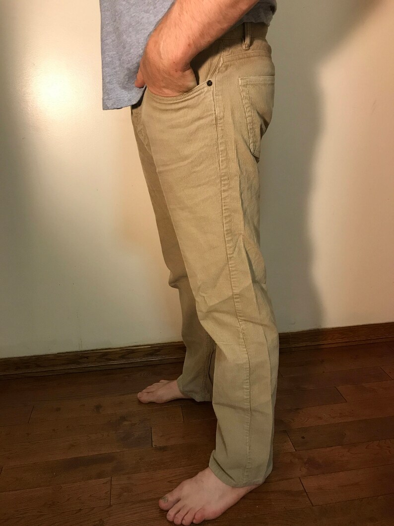 K&ouml;nnte beinhalten: Eine beige Cordhose mit gerader Beinweite. Die Hose hat eine dezente Textur und einen klassischen Stil.