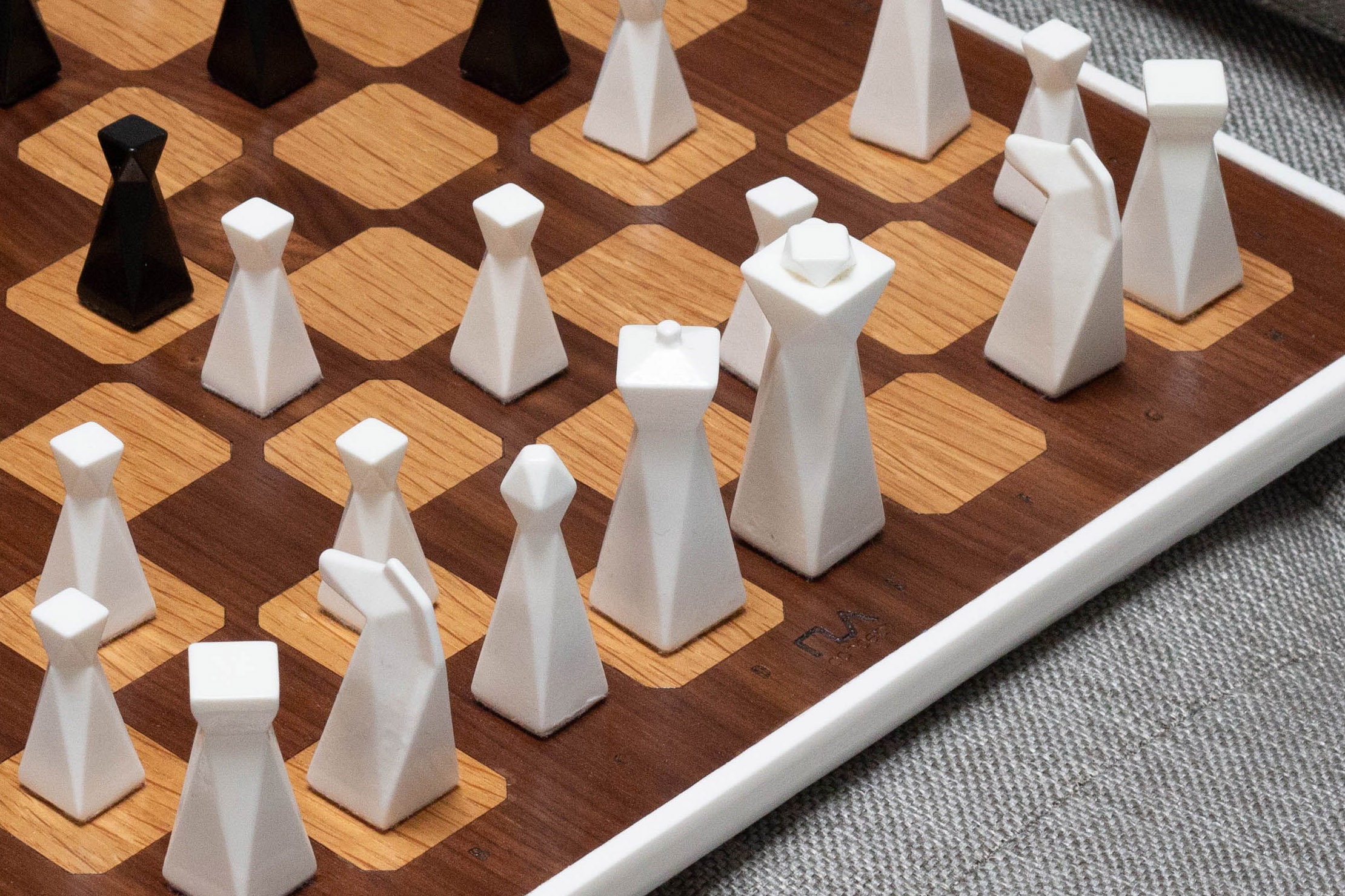 Woman Hand Holding a White Queen Piece Over a Chess Board