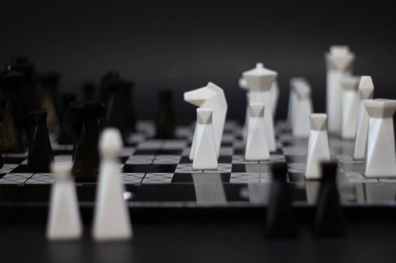 Modern geometric handmade resin chess pieces, elegantly weighted for balance and style. Unique designs perfect for board games, home decor, or a luxury personalized gift. Chessboard not included. Sleek, minimalist aesthetic ideal for any interior.