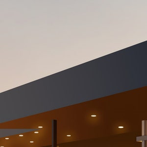 May include: A modern building with a dark blue roof and a brown overhang. The overhang has several recessed lights.