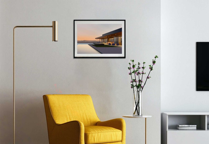 May include: A framed print of a modern house with a pool and a view of the sunset. The house has a flat roof and large windows. The pool is rectangular and surrounded by a concrete deck. The sunset is in the background and is a soft pink and orange color.