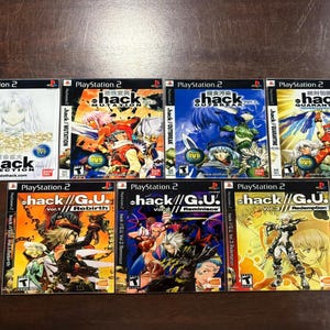 May include: A collection of seven PlayStation 2 video game cases. The game titles include .hack//INFECTION, .hack//MUTATION, .hack//OUTBREAK, and .hack//QUARANTINE. The .hack//G.U. series includes Vol.1/Rebirth, Vol.2/Reminisce, and Vol.3/Redemption. The cases feature colorful anime-style artwork.
