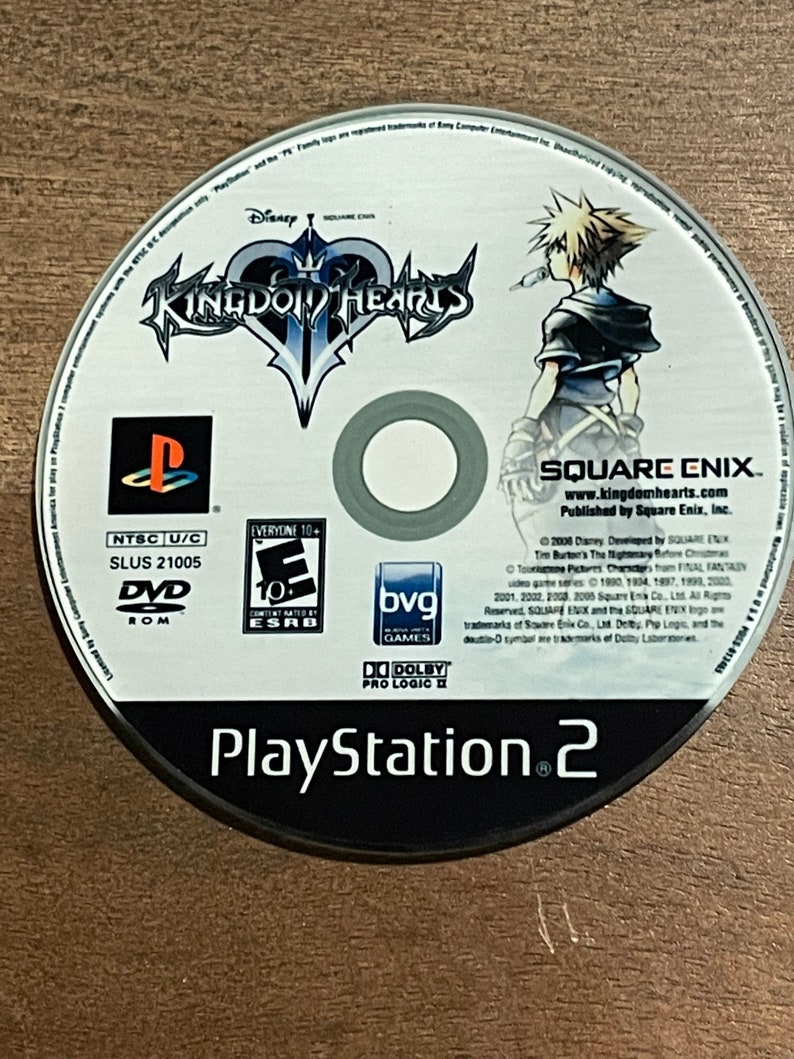 May include: A Kingdom Hearts PlayStation 2 DVD-ROM disc. The disc features the game's logo, a character illustration, and the PlayStation 2 logo. The disc is rated "E10+" by the ESRB.