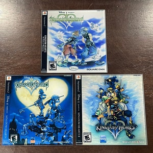 May include: Three PlayStation 2 video game cases featuring the "Kingdom Hearts" series. The top case is "Kingdom Hearts: Chain of Memories", the bottom left is "Kingdom Hearts", and the bottom right is "Kingdom Hearts II". Each case has colorful character art.