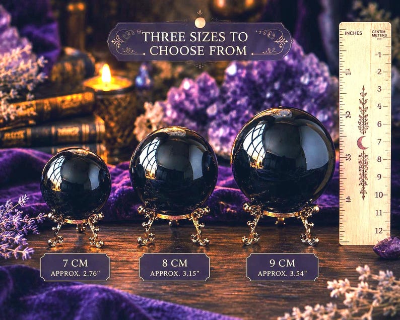 May include: Three polished black spheres on ornate gold-toned metal stands. A wooden ruler shows sizes of 7 cm, 8 cm, and 9 cm. Text reads: THREE SIZES TO CHOOSE FROM, 7 CM, 8 CM, and 9 CM. The spheres are arranged in a row from smallest to largest.