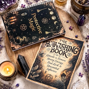 May include: Two books with black covers featuring gold-toned occult illustrations and text. The top spiral-bound book is titled Protective Magic. The bottom book is titled The Banishing Book: Rituals to Remove Heavy Energy, Bad Luck & Unwanted Influence.