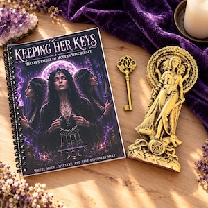 May include: A spiral-bound book titled Keeping Her Keys: Hecate's Ritual of Modern Witchcraft, featuring a dark purple cover with a woman holding keys. Beside it lies a gold-colored ornate key and a gold-colored statue of a three-headed figure.