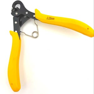 May include: A pair of wire loop forming pliers with yellow handles and black metal components. The text "2.25mm" is printed on one handle. The pliers are open, displaying the loop-forming jaws and a spring.