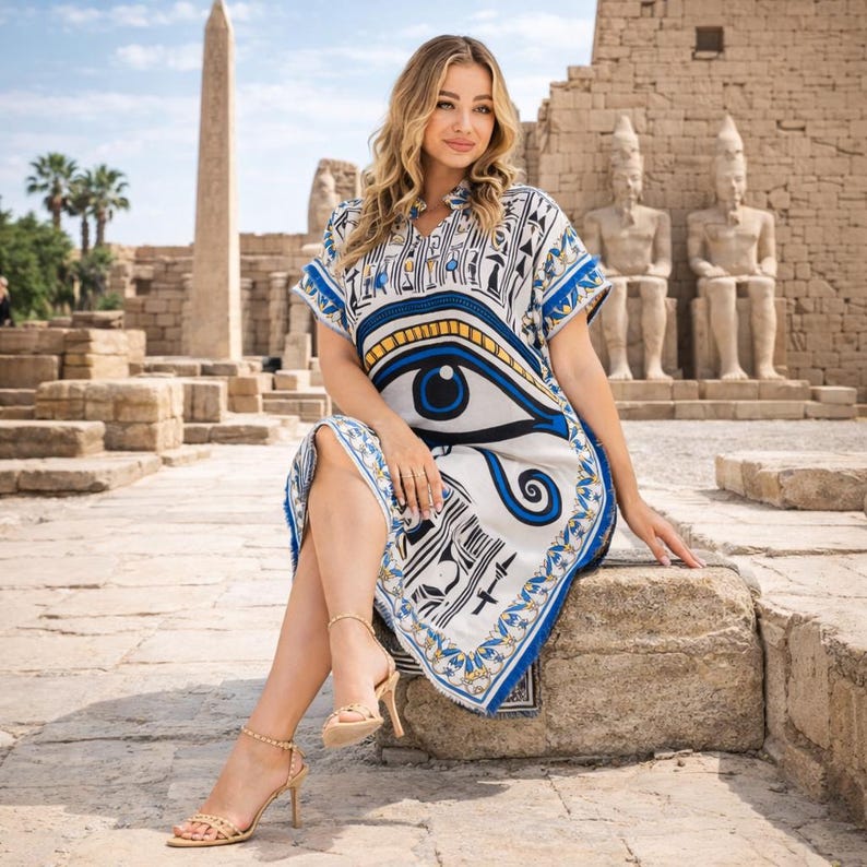 Side profile of Egyptian embroidery caftan showing decorative border and relaxed fit on model