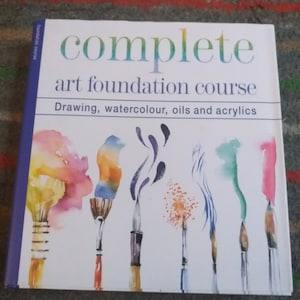 May include: A book titled "Complete Art Foundation Course" with the subtitle "Drawing, watercolour, oils and acrylics". The cover features a watercolour illustration of paintbrushes with colourful paint splatters.
