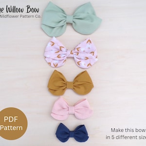 May include: Five different sizes of fabric bows in various colours and patterns, including green, pink with floral print, mustard yellow, light pink, and navy blue. The text "The Willow Bow by Wildflower Pattern Co." is at the top of the image. The text "PDF Pattern" is in a circle at the bottom left of the image. The text "Make this bow in 5 different sizes!" is at the bottom right of the image.