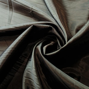May include: Black sheer fabric with a silky sheen. The fabric is draped and folded, creating a soft, flowing texture.