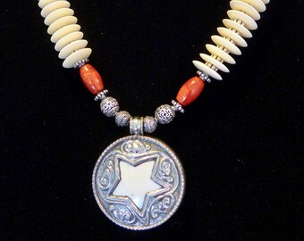 Tibetan Star Repousse, with coral, bone and silver. Matching earrings