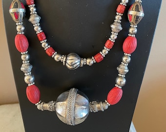 TWO IN ONE. Large Yemen Focal Bead on necklace 1 + red Nepalese melon beads and nepalese inlaid beads. Necklace 2 has silver beads + Coral.