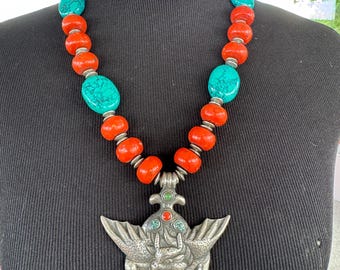 Unique vintage silver Pendant depiction of Garuda, inset with turquoise and coral. Strung with natural coral and natural turquoise beads