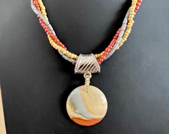 Polychrome pendant with three woven glass bead strands