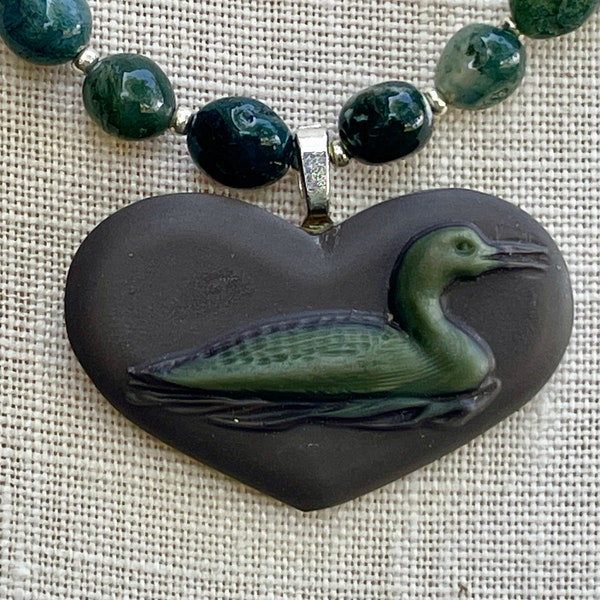 Hand-carved loon in ribbon jasper, strung with moss agate beads interspersed with silver spacers. Delicate, subtle  and beautiful