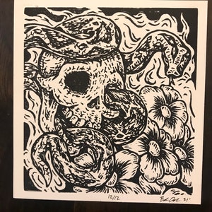 Untitled small linocut print- skull, snake, and flowers