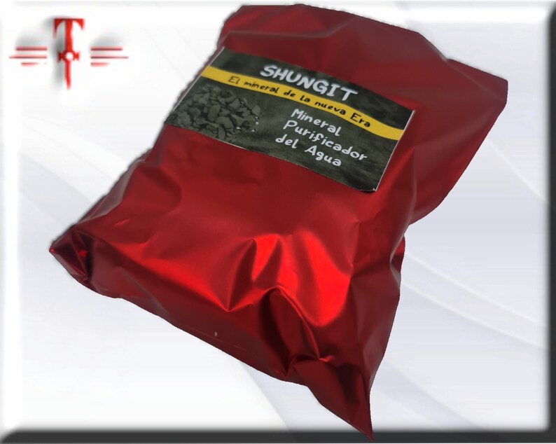 May include: A red pouch with a label that reads "Shungit El mineral de la nueva Era Mineral Purificador del Agua".