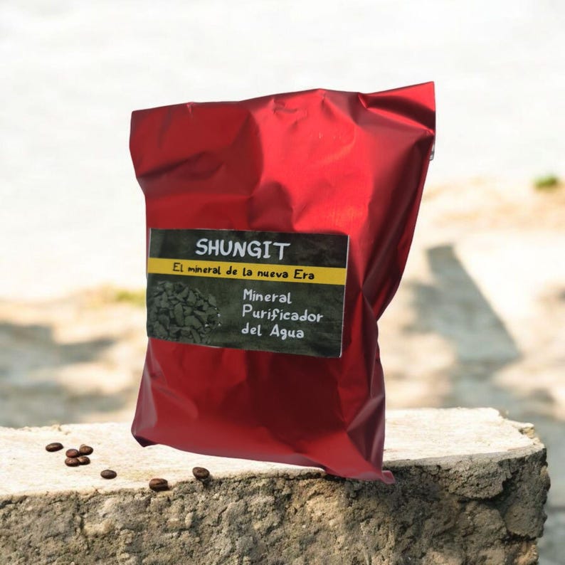 May include: A red pouch with a label that reads "Shungit El mineral de la nueva Era Mineral Purificador del Agua".