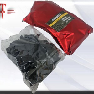 May include: Two bags of black shungite stones. One bag is red and says "Shungite El mineral de la vida" and "Natural Purificador del Agua".