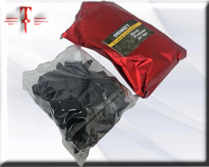 May include: Two bags of black shungite stones. One bag is red and says "Shungite El mineral de la vida" and "Natural Purificador del Agua".
