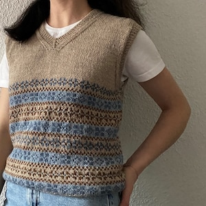May include: A brown and blue striped knitted vest with a V-neck.