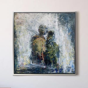 May include: Abstract oil painting in a silver frame. The artwork depicts two figures with textured brushstrokes in shades of green, yellow, and blue. The painting hangs on a white wall above a dark gray cabinet.