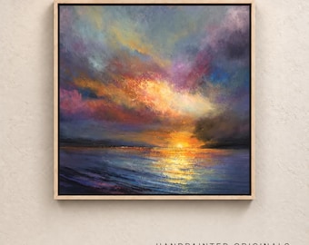 May include: A square framed oil painting depicting a sunset over a body of water. The sky features vibrant clouds in shades of orange, yellow, purple, and blue. The sun is low on the horizon, casting a golden reflection across the dark blue water.