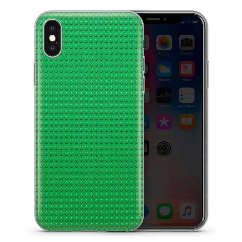 May include: A clear phone case with a green Lego-like pattern. The case is designed to fit an iPhone.