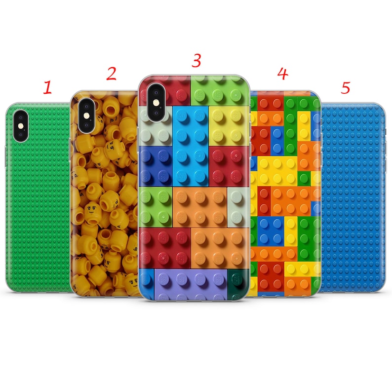 May include: Five different phone cases with various designs. The first case is green with a pattern of small squares. The second case has a pattern of yellow heads. The third case has a pattern of colorful Lego bricks. The fourth case has a pattern of colorful Lego bricks in a grid pattern. The fifth case is blue with a pattern of small squares.