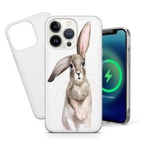 May include: A clear phone case with a watercolor illustration of a brown rabbit. The rabbit is looking at the camera with its ears perked up. The case is designed for an iPhone with a camera bump.