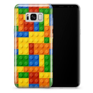 May include: A clear phone case with a colorful Lego brick pattern. The case is designed for a Samsung Galaxy S8 phone.