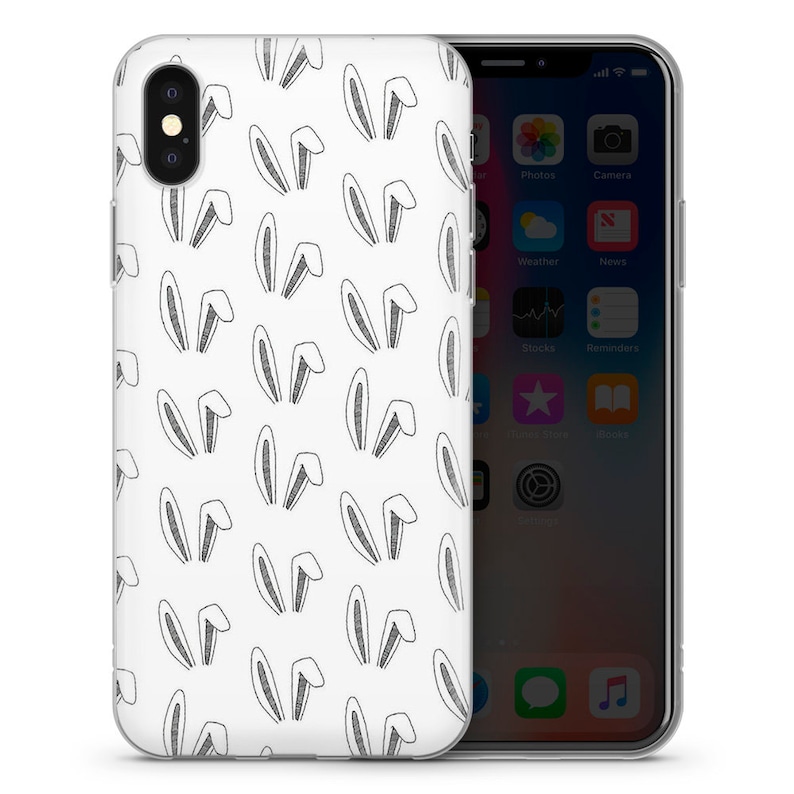May include: A clear phone case with a white background and a repeating pattern of black bunny ears.