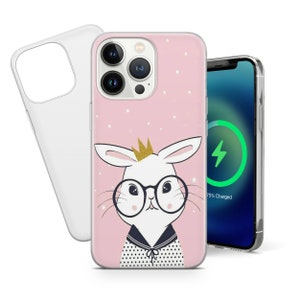 May include: A pink phone case with a white bunny wearing glasses and a gold crown. The bunny has a black and white polka dot shirt and a navy blue collar. The background is pink with gold stars.