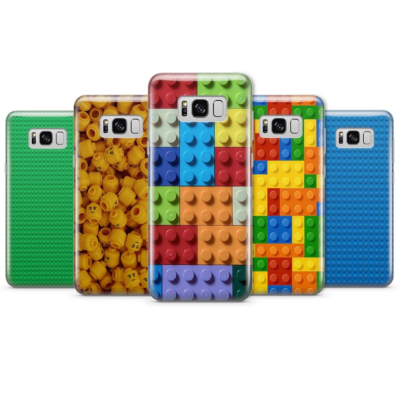 May include: Five different phone cases with a Lego theme. The cases are all for the Samsung Galaxy S8. The cases feature different Lego designs, including a green case with green Lego bricks, a yellow case with yellow Lego heads, a blue case with blue Lego bricks, a red case with red, blue, yellow, and green Lego bricks, and a yellow case with yellow, red, blue, and orange Lego bricks.