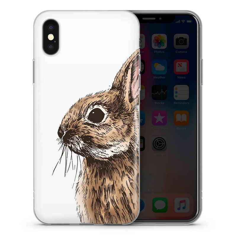 May include: A clear phone case with a brown and white illustration of a rabbit's head. The rabbit is looking to the right and has a white background.