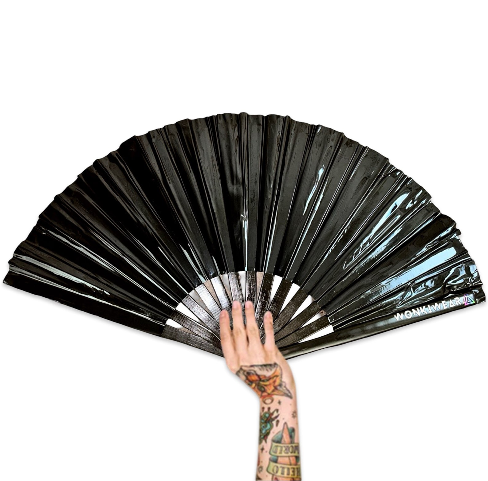 Large black vinyl gothic fan with high-shine finish held by tattooed hand, featuring WonkiWear logo on the edge.