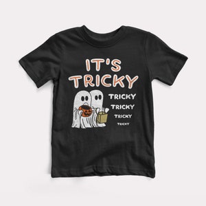 May include: Black t-shirt with a white ghost graphic and the text "It's Tricky" and "Tricky" repeated four times.