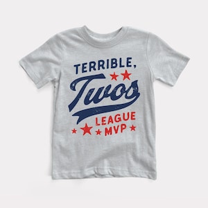 May include: A light gray t-shirt with a blue and red graphic that says "Terrible Twos League MVP" with stars.