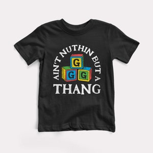 May include: Black t-shirt with a white graphic of colorful blocks spelling "AIN'T NUTHIN BUT A THANG" with the letter G on each block.