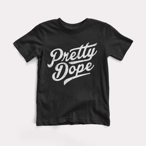 May include: Black t-shirt with a white vintage-style graphic that says "Pretty Dope".