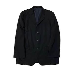 May include: A black blazer with a three-button closure and two front pockets. The blazer has a notched lapel and long sleeves. The interior lining is a dark blue color. The blazer is a classic style.