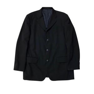 May include: A black blazer with a three-button closure, two front pockets, and a notched lapel. The jacket has a classic design and a dark navy blue lining. The sleeves are long and the fabric appears to be a smooth, woven material.